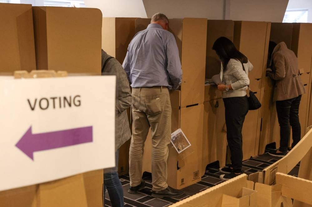 Voters cast their ballots ahead of the national election at an Australian Electoral Commission early voting centre, in the Central Business District of Sydney, Australia May 17, 2022. ― Reuters pic