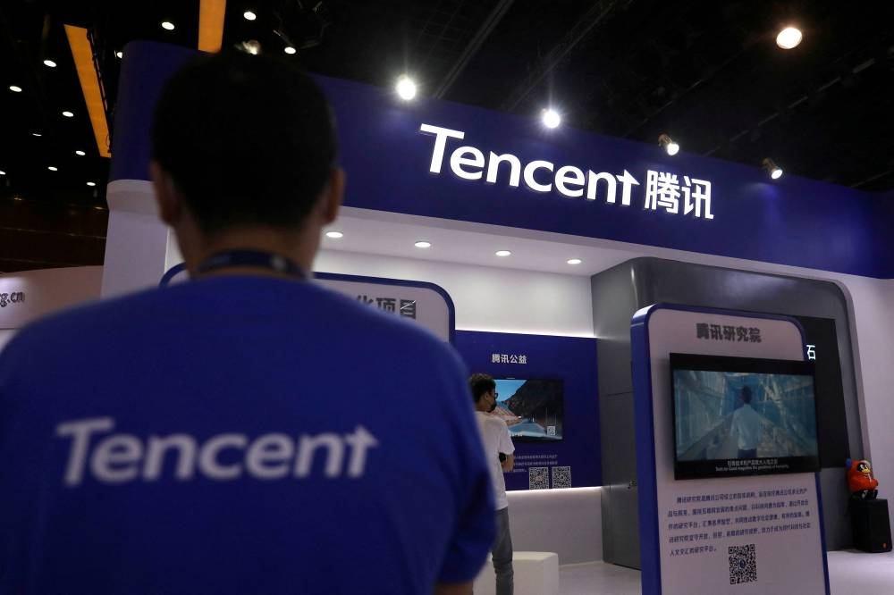 A staff member is seen at a booth of Tencent at an exhibition during China Internet Conference in Beijing July 13, 2021. — Reuters pic