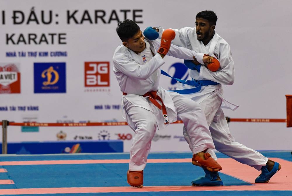 Malaysia’s Sureeya Sankar Hari Sankar (right) in action during the men’s team kumite event against Indonesia at the Sports Competition Centre in Ninh Binh, May 20, 2022. — Bernama pic 