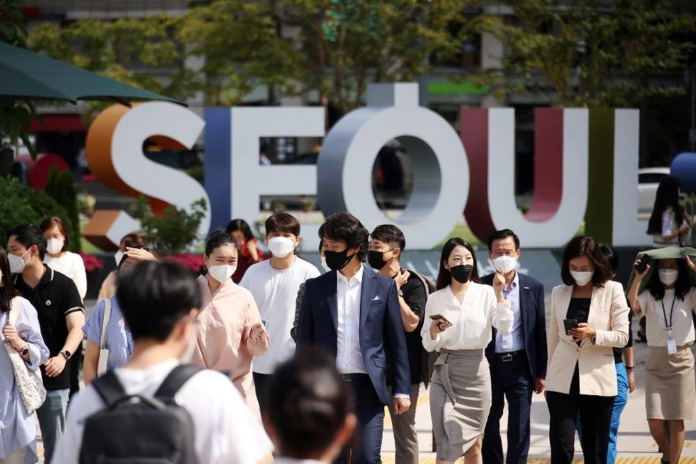 Commuters wearing masks to avoid contracting Covid-19) walk on a zebra crossing in Seoul, South Korea September 24, 2021. — Reuters pic