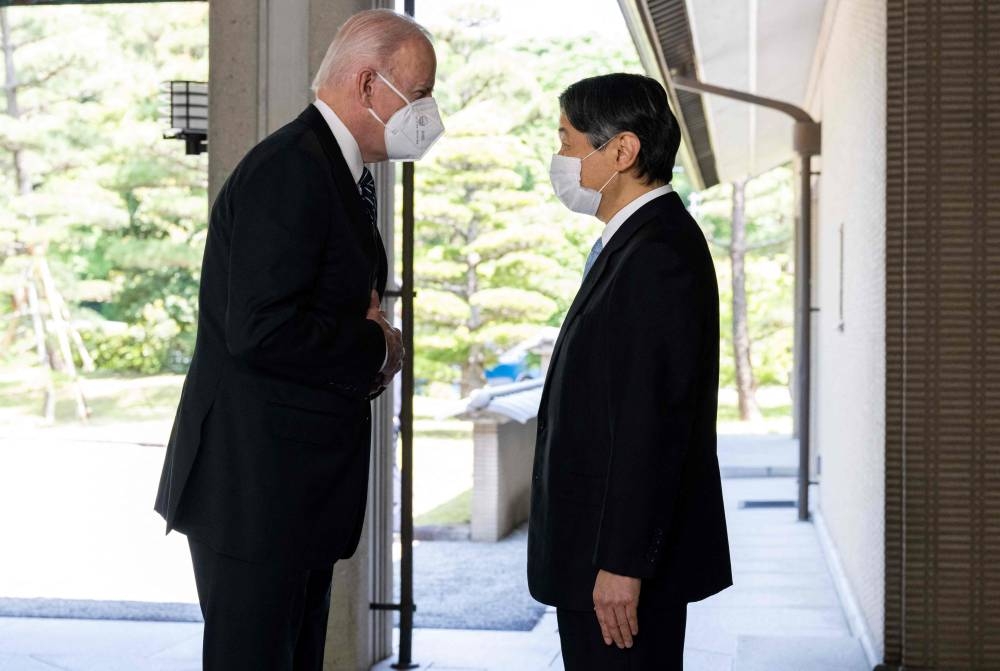 Japan's Emperor Naruhito greets US President Joe Biden prior to their meeting at the Imperial Palace in Tokyo May 23, 2022. — SAUL LOEB/Pool/AFP pic