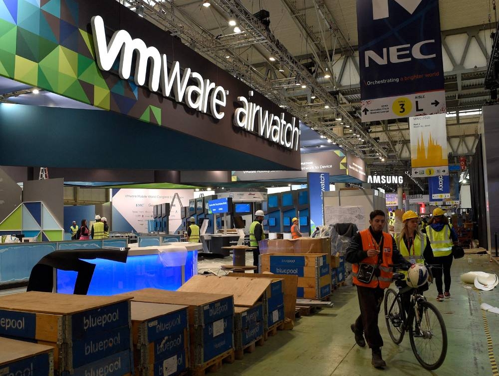  In this file photo taken on February 20, 2016, people walk past the VMware company stand in Barcelona, Spain. — AFP pic