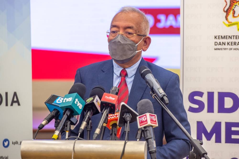 Rural Development minister Mahdzir Khalid speaks to the media during a press conference on the implementation of post-flood house repair and construction in Putrajaya, January 10, 2022. — Picture by Shafwan Zaidon