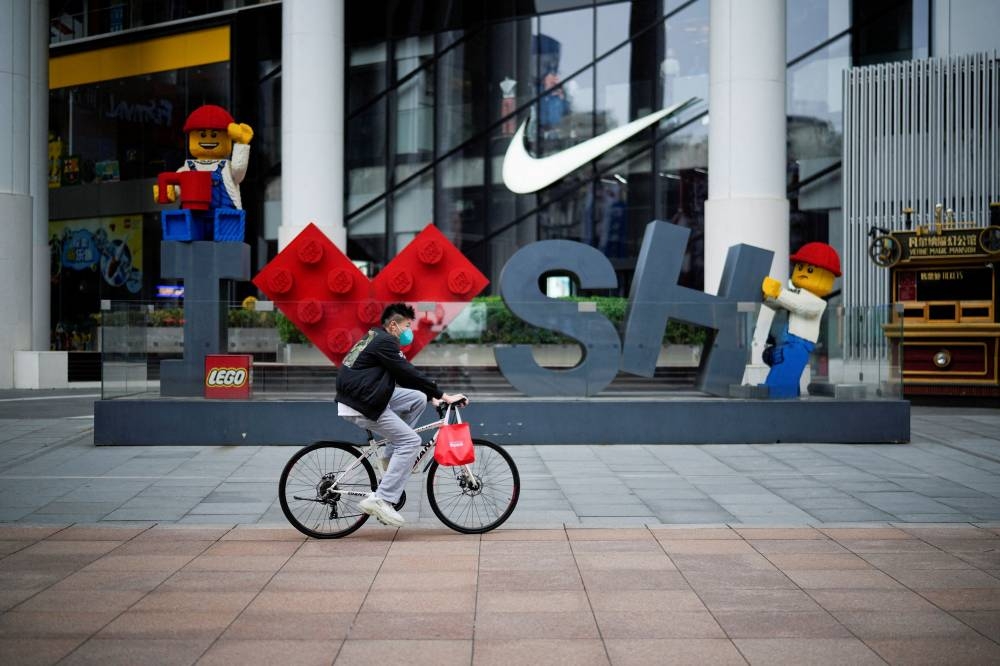 A man rides a bicycle at a main shopping area during lockdown, amid the Covid-19  pandemic, in Shanghai, China, May 26, 2022. — Reuters pic