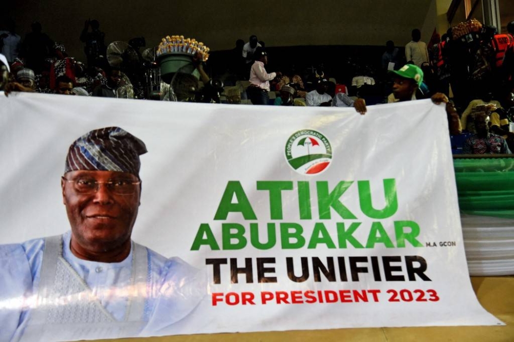 Supporters hold a banner of Nigerian former Vice President Atiku Abubakar during the opposition Peoples Democratic Party's (PDP) primaries in Abuja, on May 28, 2022. Former Nigerian vice president Atiku Abubakar on May 28, 2022 won the opposition party PDP's primary to choose its candidate for the 2023 presidential election, according to ballot results. — AFP pic