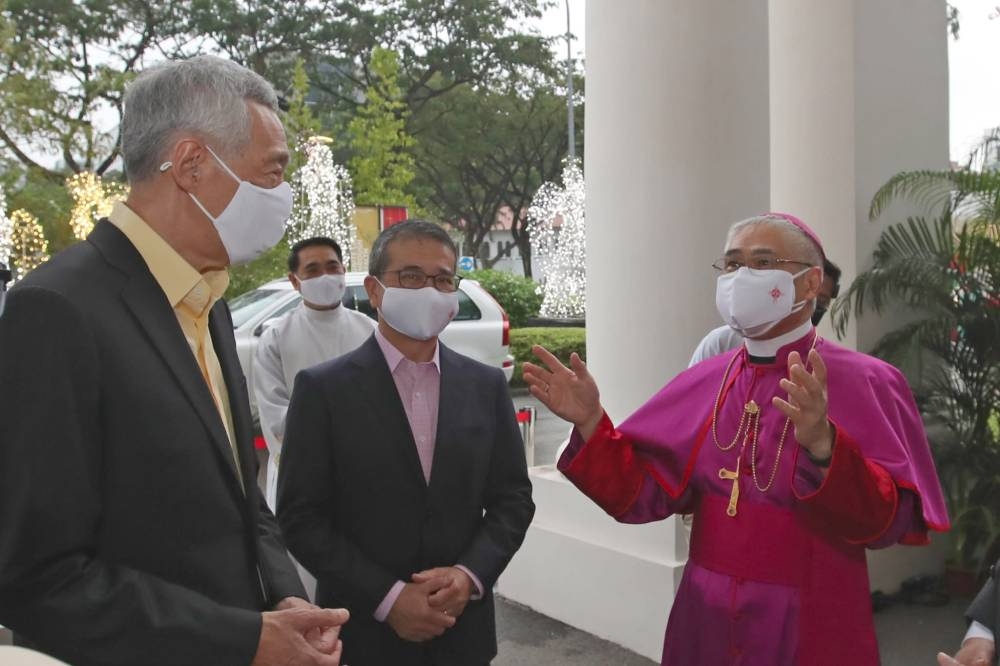 Prime Minister Lee Hsien Loong (left) pictured with Archbishop Goh (right) at the Cathedral of the Good Shepherd in December 2021 at an event to mark the bicentennial of the Catholic Church in Singapore. — Ministry of Communications and Information pic via TODAY