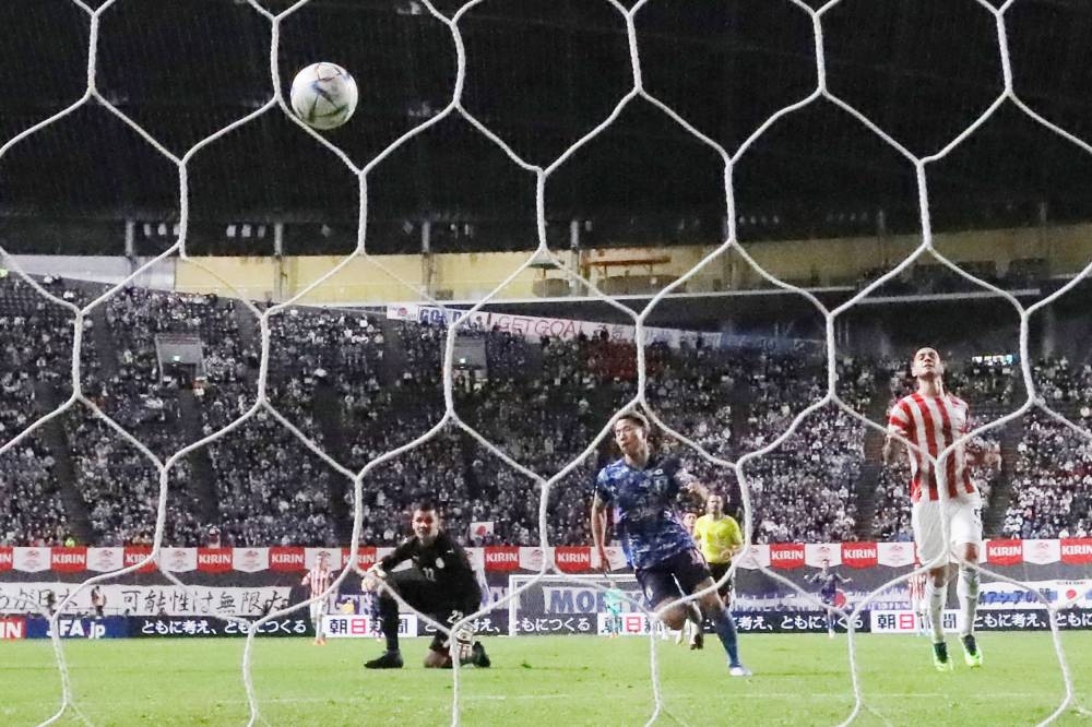 Japan’s forward Takuma Asano scores a goal during the international friendly match between Japan and Paraguay at Sapporo Dome in Sapporo, Hokkaido prefecture June 2, 2022. — Jiji Press handout pic via AFP 