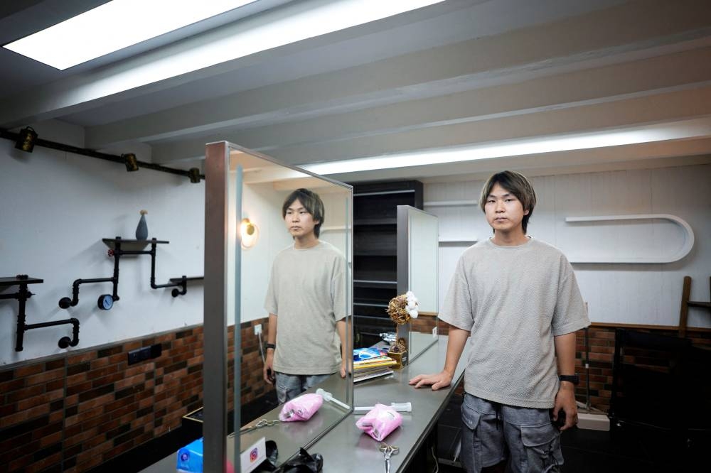 Li Menghua, a barbershop owner poses for a picture at his closed barber shop after the lockdown placed to curb the Covid-19 outbreak was lifted in Shanghai, China June 2, 2022. — Reuters pic