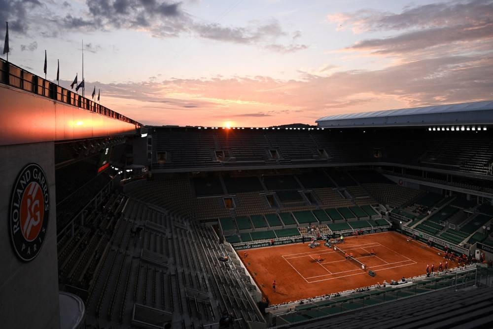 Members of the ground staff prepare the Philippe Chatrier court ahead of a singles second round tennis match on Day 5 of The Roland Garros 2021 French Open tennis tournament in Paris June 3, 2021. — AFP pic 