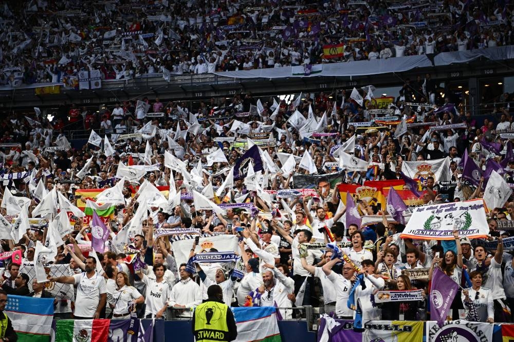 Real Madrid supporters cheer prior to the Uefa Champions League final match between Liverpool and Real Madrid at the Stade de France in Saint-Denis, north of Paris, May 28, 2022. — AFP pic 