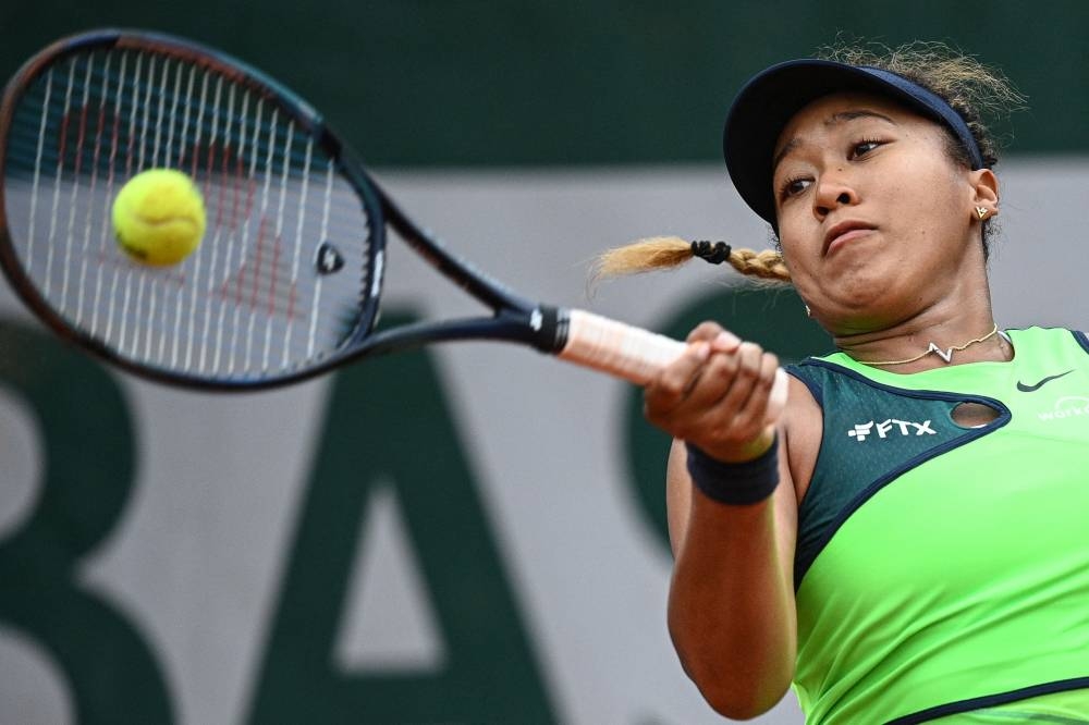 Japan’s Naomi Osaka returns the ball to US’ Amanda Anisimova during their women’s singles match on day two of the Roland-Garros Open tennis tournament at the Court Suzanne-Lenglen in Paris, May 23, 2022. — AFP pic 