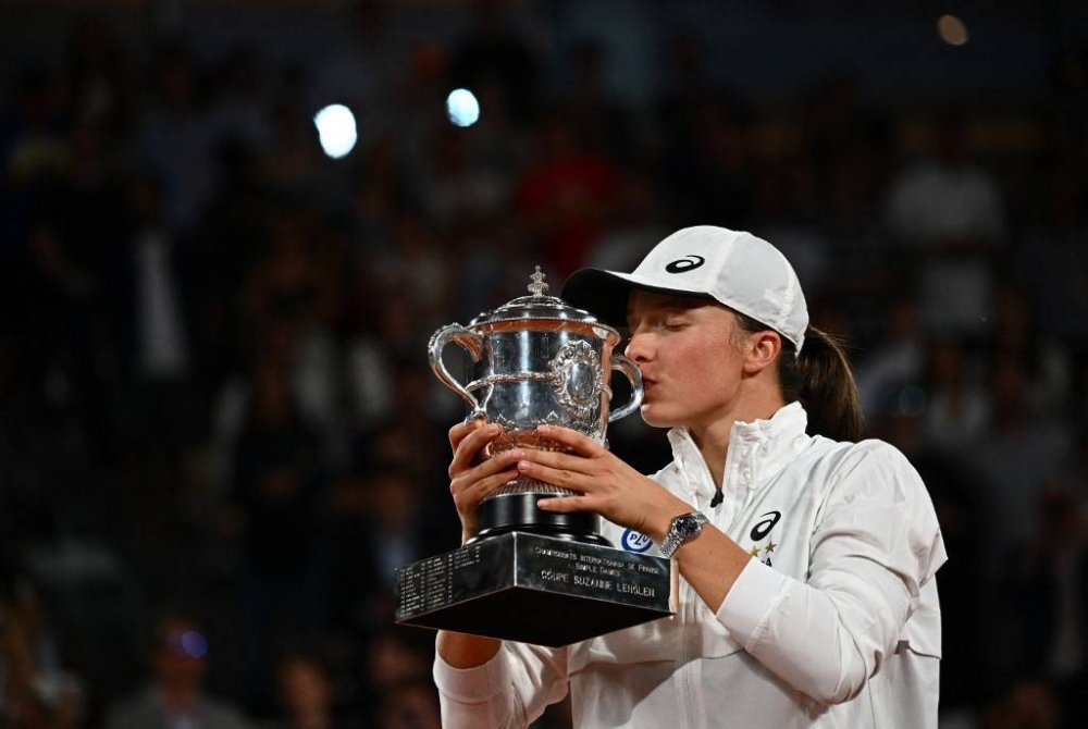 Poland’s Iga Swiatek kisses the trophy after winning against US’ Coco Gauff at the end of their women’s single final match on day fourteen of the Roland-Garros Open tennis tournament at the Court Philippe-Chatrier in Paris on June 4, 2022. — AFP pic