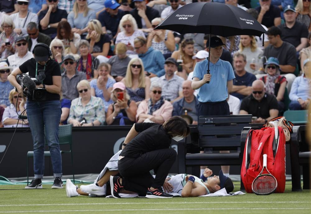 Britain’s Emma Raducanu receives medical attention during her first round match against Switzerland’s Viktorija Golubic at the Nottingham Open, Nottingham Tennis Centre, Nottingham, Britain, June 7, 2022. — Action Images via Reuters