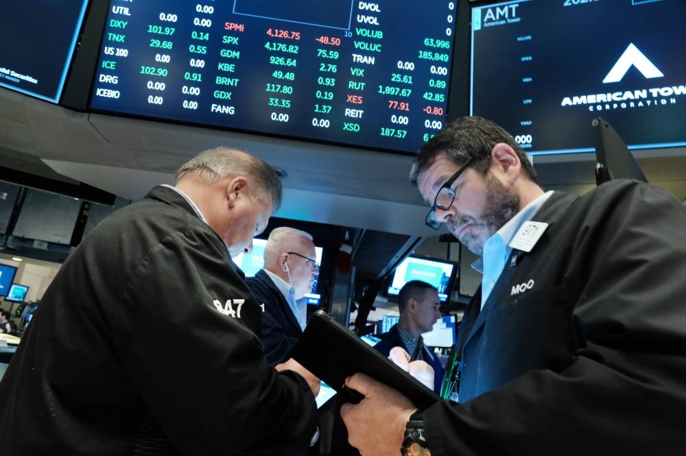 Traders work on the floor of the New York Stock Exchange (NYSE) at the start of the trading day on June 3, 2022 in New York City. — AFP pic