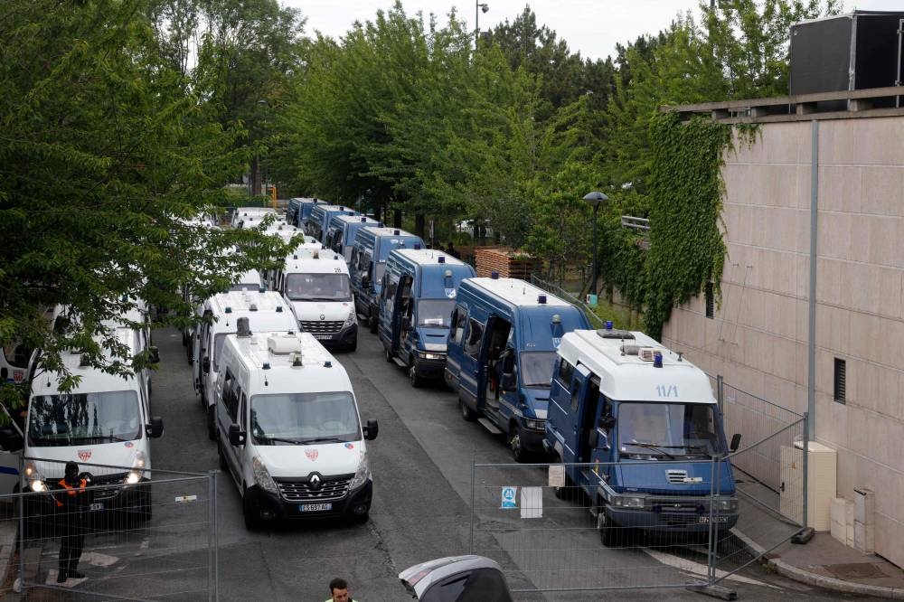 Gendarmes and riot police vans are parked outside the Stade de France before the UEFA Nations League - League A Group 1 first leg football match between France and Denmark in Saint-Denis on June 3, 2022.