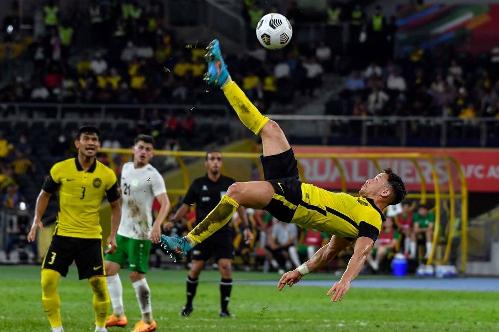 Harimau Malaya’s Darren Lok in acrobatic action during the match against Turkmenistan at the National Stadium in Bukit Jalil, Kuala Lumpur, June 8, 2022. — Bernama pic 