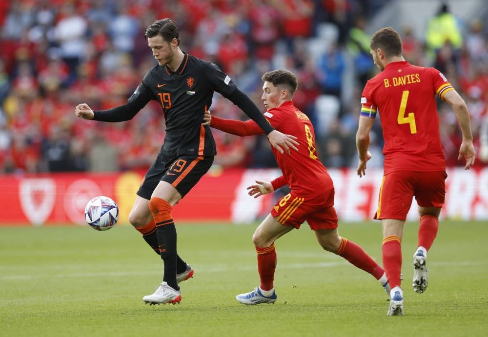 Netherlands' Wout Weghorst in action against Wales' Harry Wilson at the Cardiff City Stadium, Cardiff June 8, 2022. — Reuters pic