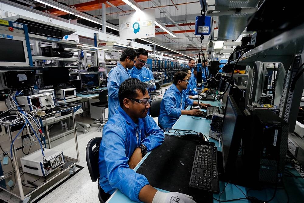 Workers are pictured at their respective stations at a factory in Batu Maung, November 22, 2019. — Picture by Sayuti Zainudin