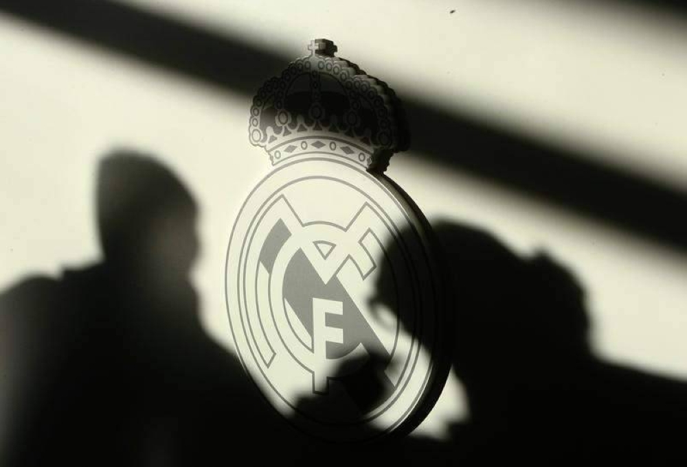 Shadows of reporters are seen on Real Madrid’s logo during a news conference in this December 9, 2008 file photo. — Reuters pic 