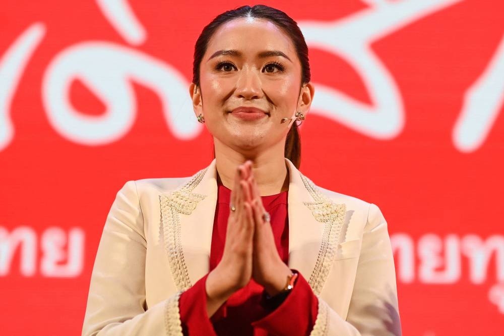 In this file photo taken on April 24, 2022, Paetongtarn Shinawatra, youngest daughter of former Thai prime minister Thaksin Shinawatra, gestures during the Pheu Thai party's annual meeting in Bangkok. — AFP pic