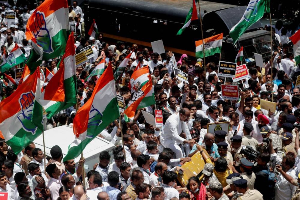 Police officers attempt to stop supporters of India's main opposition Congress party at a barricade as they attempt to reach the Enforcement Directorate office during a protest after party leader Rahul Gandhi was summoned by the Enforcement Directorate in a money laundering case, in Mumbai, India, June 13, 2022. — Reuters pic