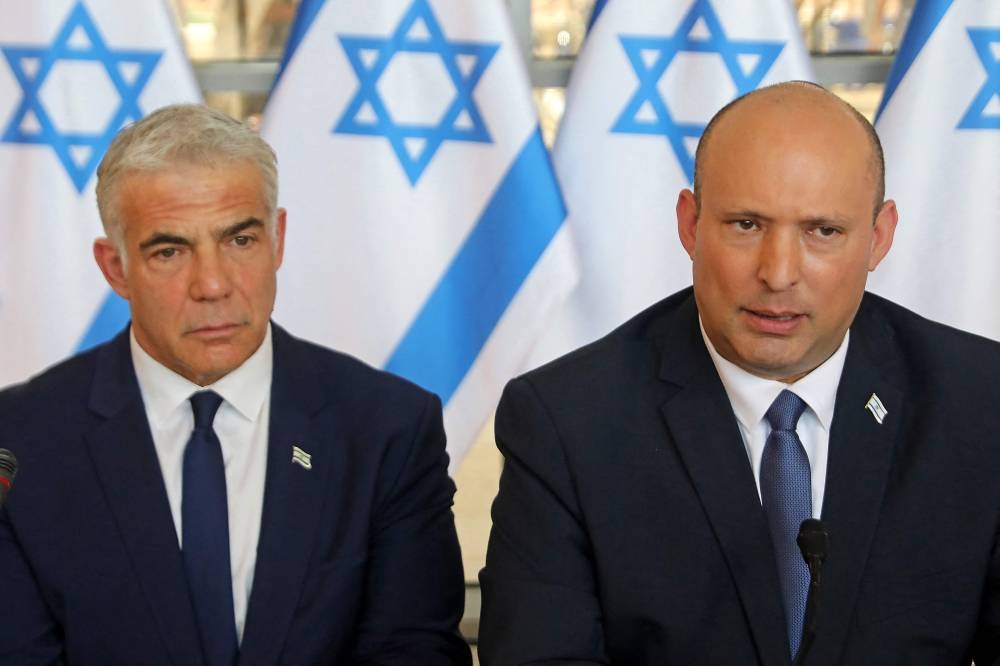 In this file photo taken on May 29, 2022 Israeli Prime Minister Naftali Bennett (right) and Foreign Minister Yair Lapid, attend a weekly cabinet meeting in Jerusalem. Lapid urged Israelis to avoid Istanbul or to return home if already there. — AFP pic