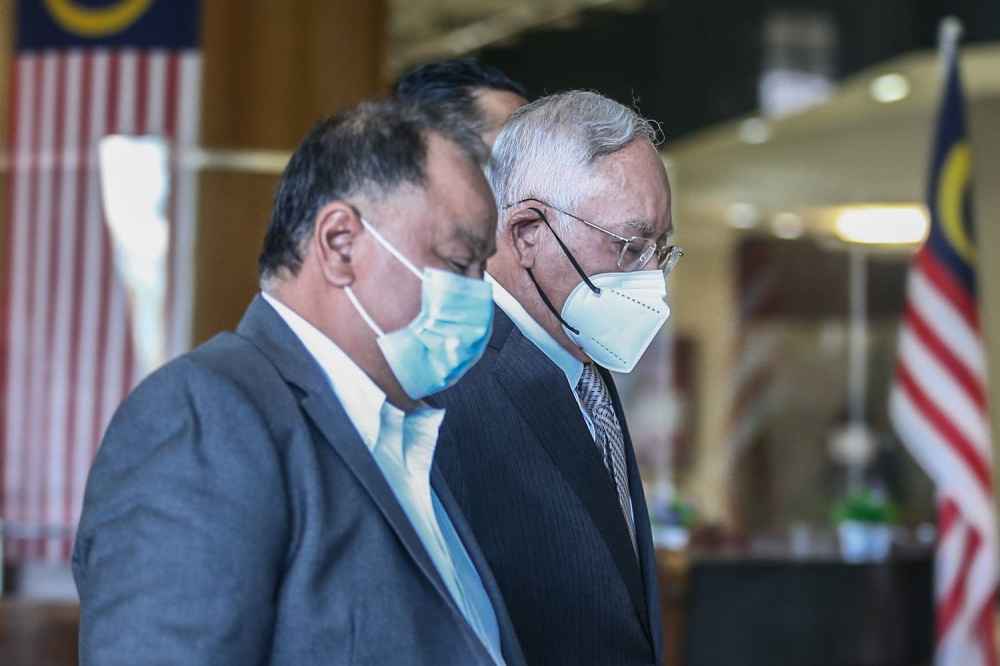 Datuk Seri Najib Razak (right) arrives at the Kuala Lumpur Court Complex on June 14, 2022. — Picture by Hari Anggara