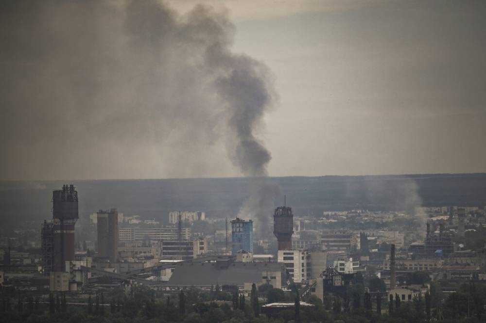 Smoke rises from the city of Severodonetsk in the eastern Ukrainian region of Donbas on June 13, 2022, amid Russian invasion of Ukraine. The cities of Severodonetsk and Lysychansk, which are separated by a river, have been targeted for weeks as the last areas still under Ukrainian control in the eastern Lugansk region. — AFP pic