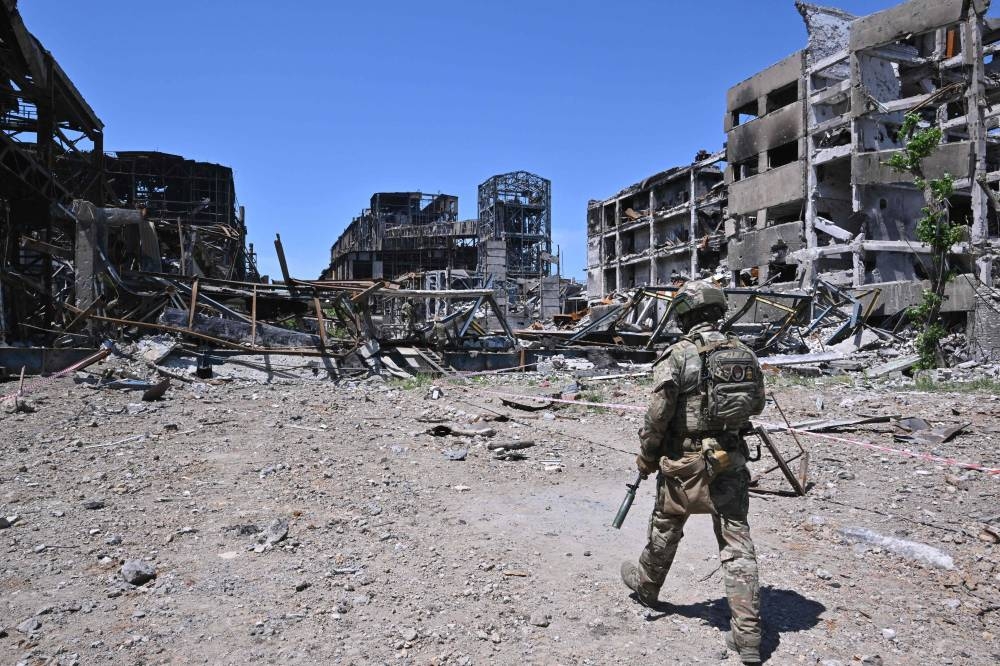 Russian serviceman patrols near the Azovstal steel plant in Mariupol, amid the ongoing Russian military action in Ukraine, on June 13, 2022. — AFP pic