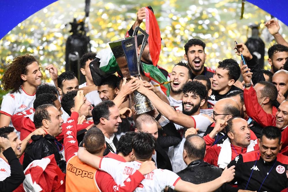 Tunisia players and officials celebrate with the trophy after their victory in the Kirin Cup football final against Japan at the Panasonic stadium in Suita, Osaka June 14, 2022. — Reuters pic