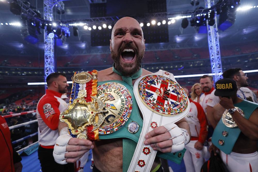 Tyson Fury celebrates with the belts after winning his fight against Dillian Whyte, London April 23, 2022. — Reuters pic