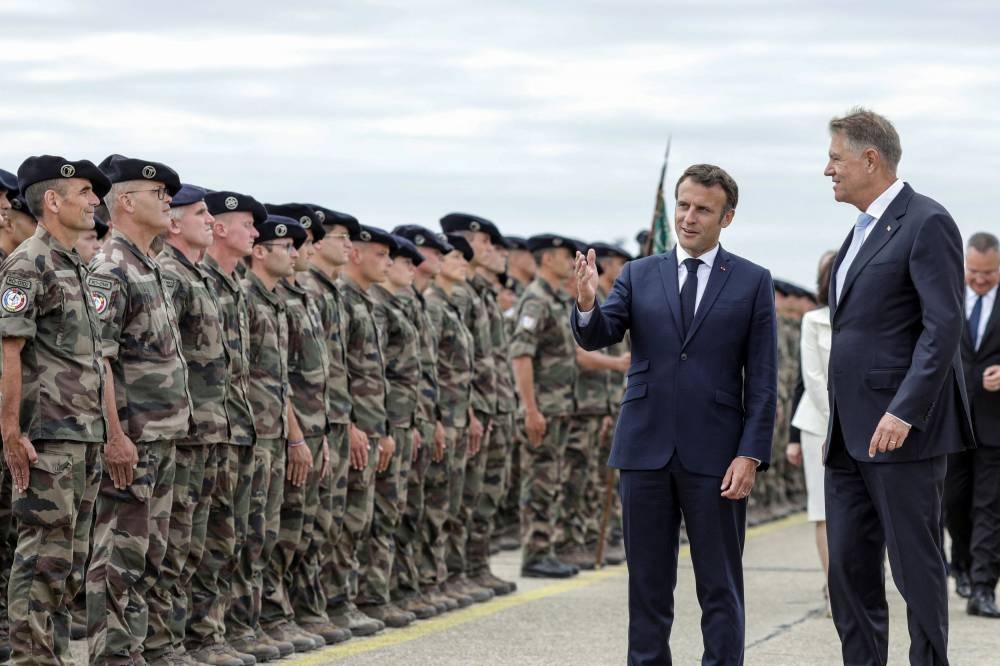 France will help reach a consensus among EU members on the issue of Moldova's application to join the bloc at a crucial Council meeting next week, Macron said. — Reuters pic