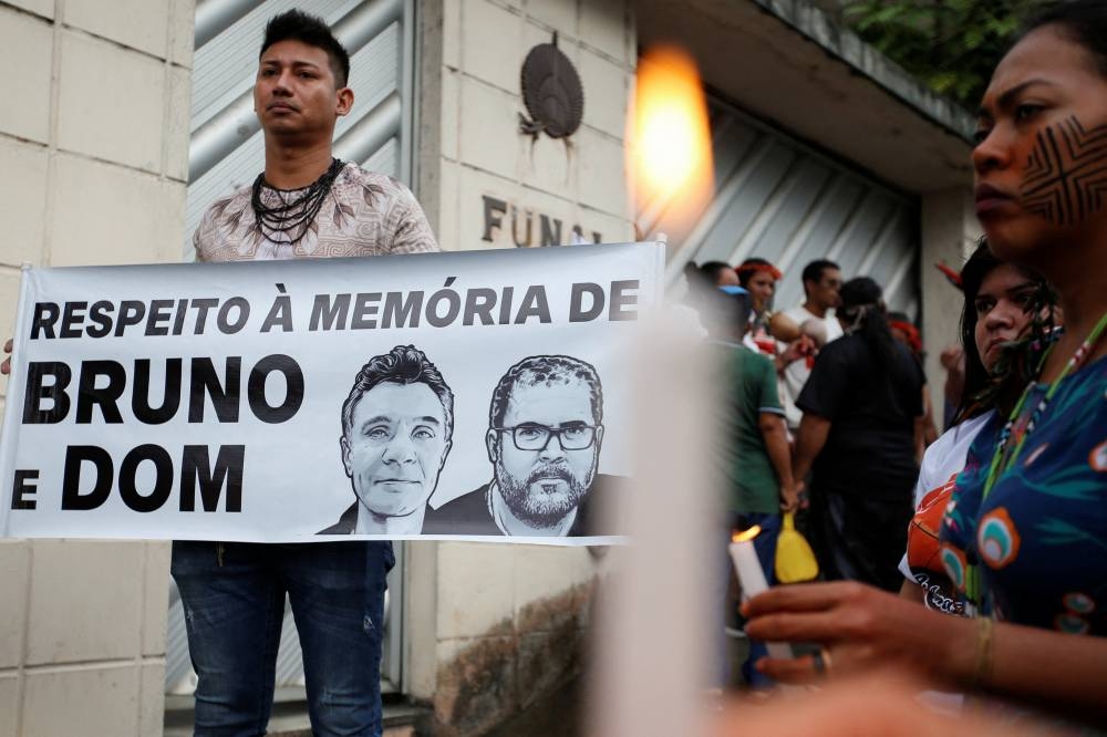 A demonstrator holds a banner reading ‘In respect of the memory of Bruno and Dom’ during a protest following the disappearance of British journalist Dom Phillips and indigenous expert Bruno Araujo Pereira in Manaus, Brazil June 15, 2022. — Reuters pic