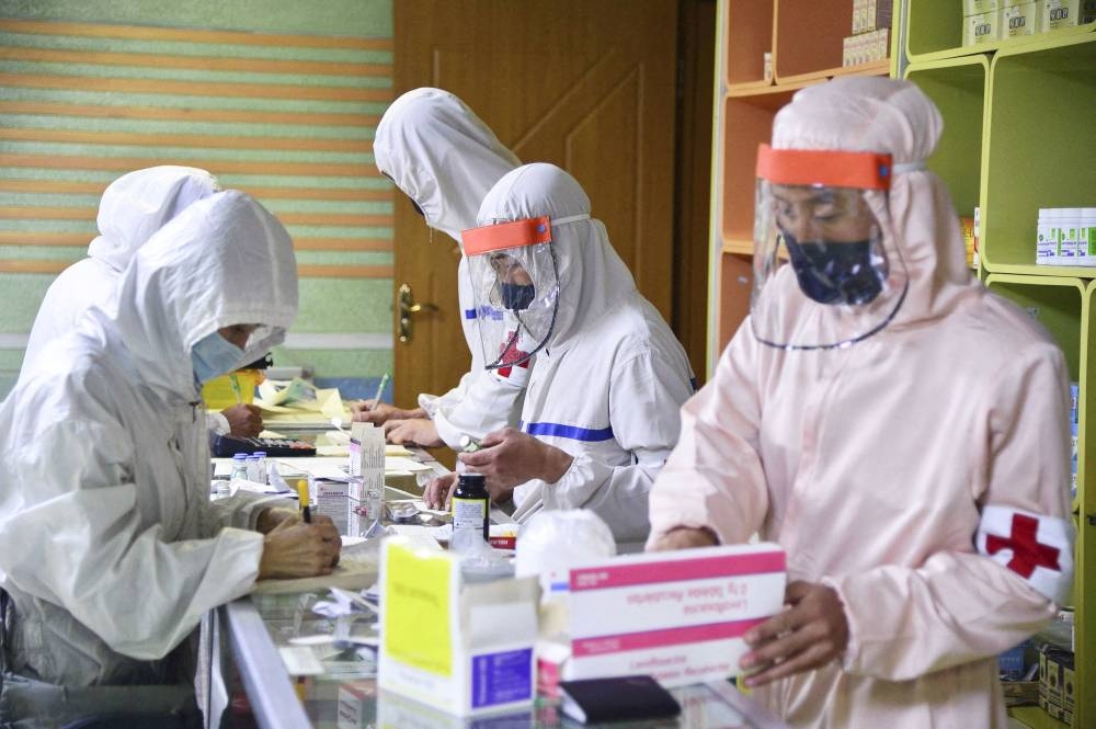 Members of the North Korean army supply medicines to residents at a pharmacy, amid growing fears over the spread of Covid-19, in Pyongyang, North Korea, in this photo released by Kyodo on May 18, 2022. — Kyodo/via Reuters