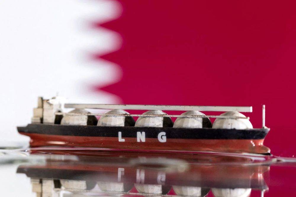 Model of LNG tanker is seen in front of Qatar's flag in this illustration taken May 19, 2022. — Reuters pic