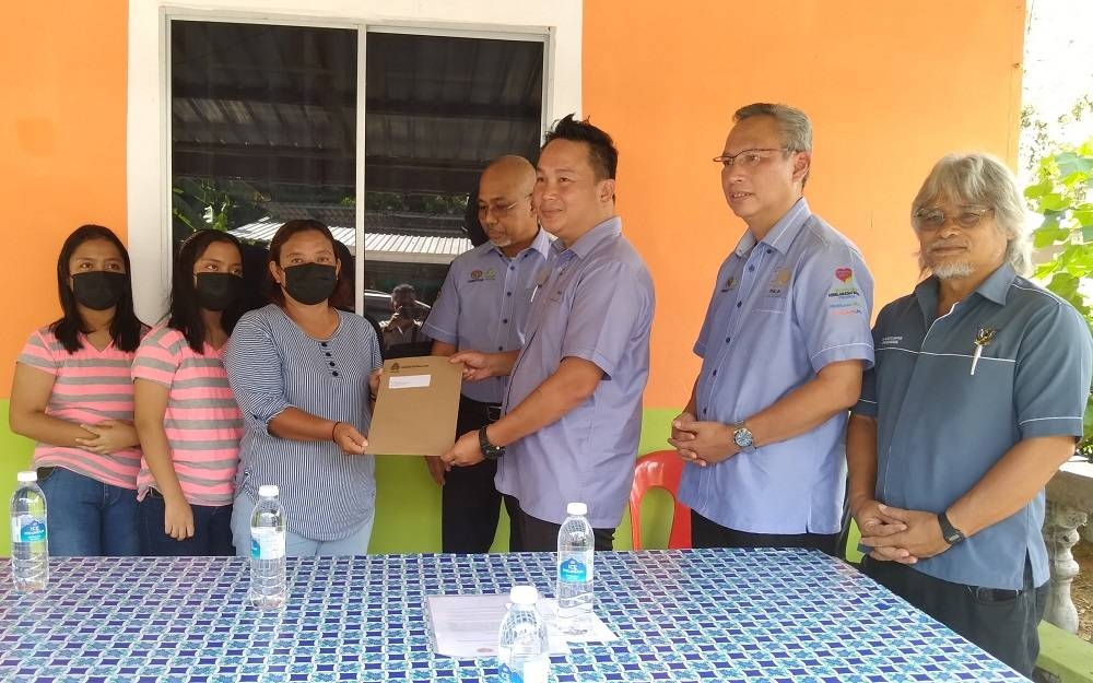 Twins in Sarawak receive Socso benefits 13 years after mother’s death