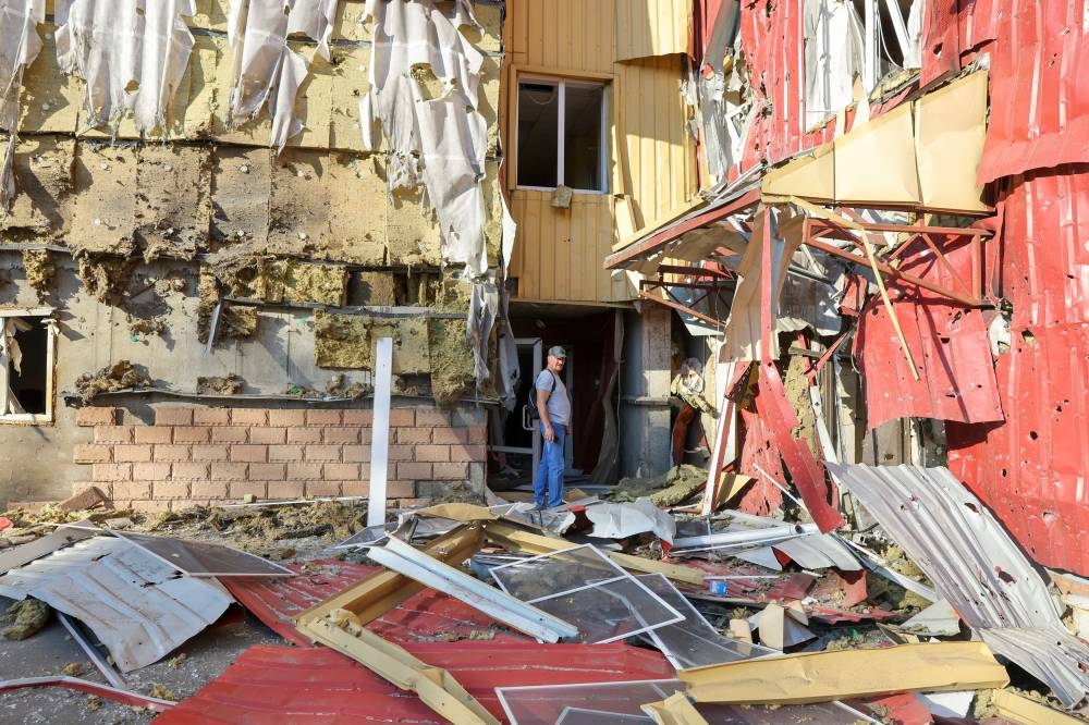 A man stands outside a damaged residential building located in Panfilova street following recent shelling in the course of Ukraine-Russia conflict in Donetsk, Ukraine June 20, 2022. ― Reuters pic