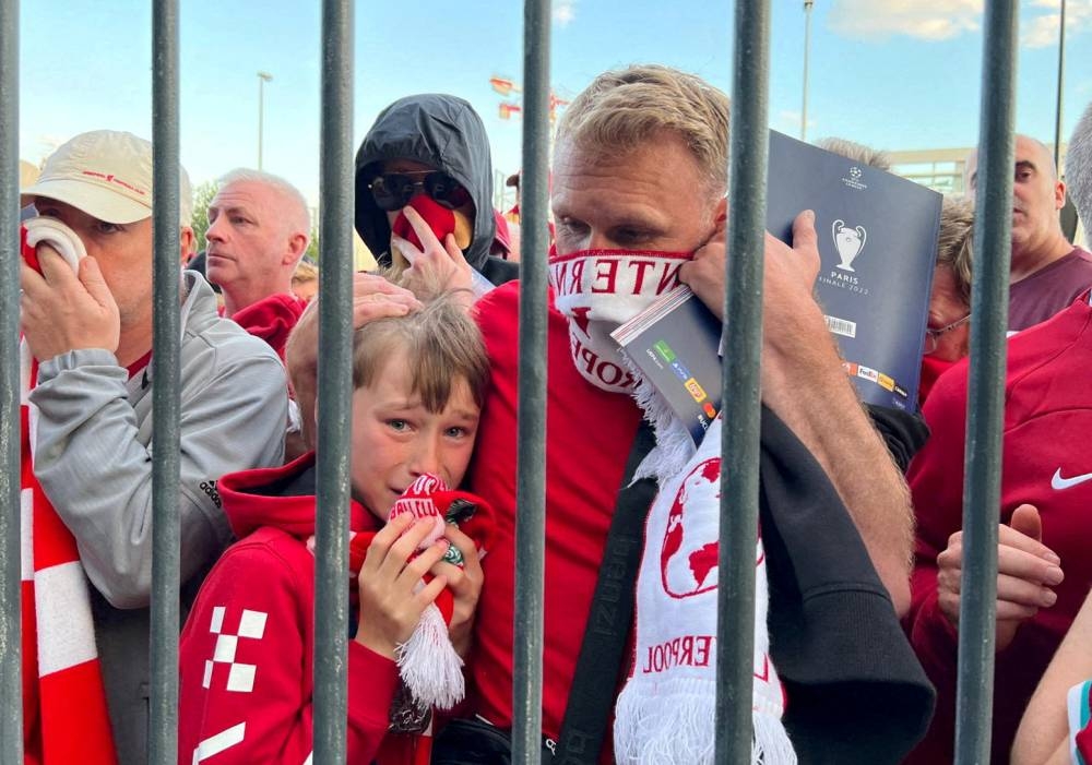 Liverpool fans react as they queue to access Stade de France before the Champions League Final, May 28, 2022. — Reuters pic