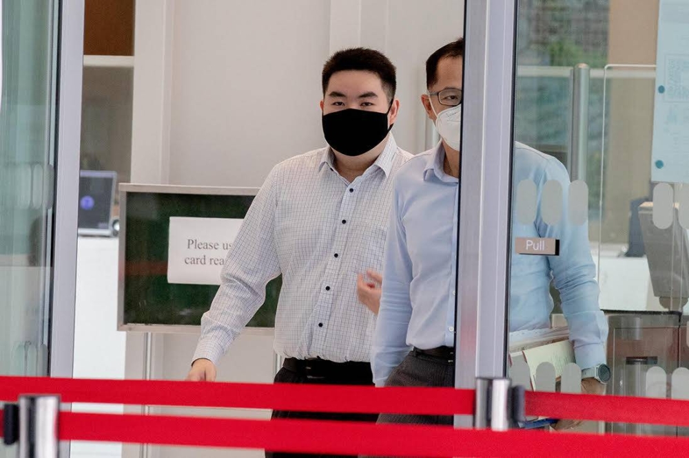 Colin Chua Yi Jin (left), 23, leaving the State Courts in July 2021. ― TODAY pic