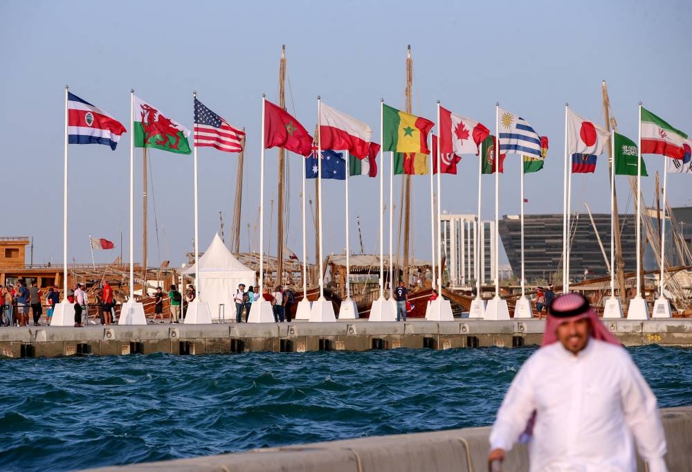 A general view shows flags of the qualified countries for the 2022 World Cup in the Qatari capital Doha during a flag-raising ceremony of the last remaining countries to qualify, June 16, 2022. — AFP pic 