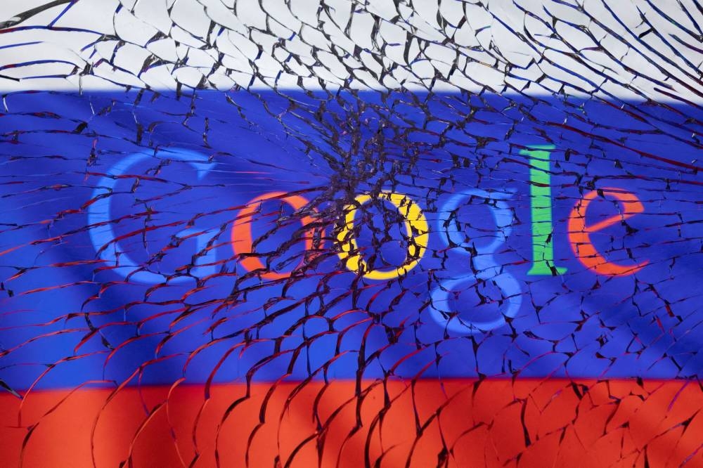 Google logo and Russian flag are seen through broken glass in this illustration taken March 1, 2022. — Reuters pic