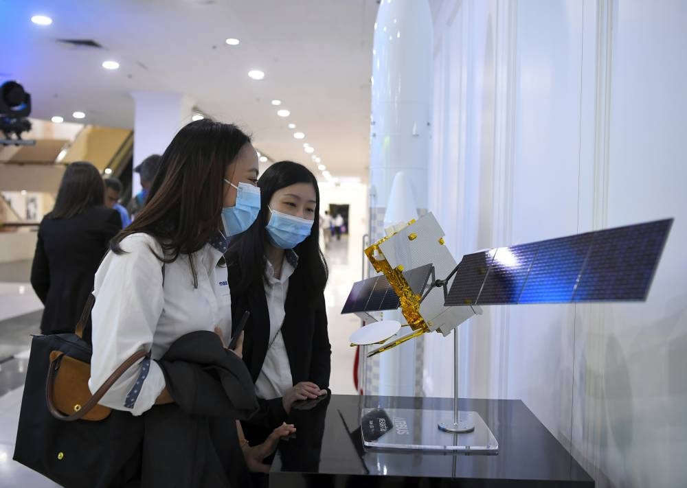 Members of the public look at a replica of the Measat-3d satellite at World Trade Centre Kuala Lumpur June 23, 2022. — Bernama pic