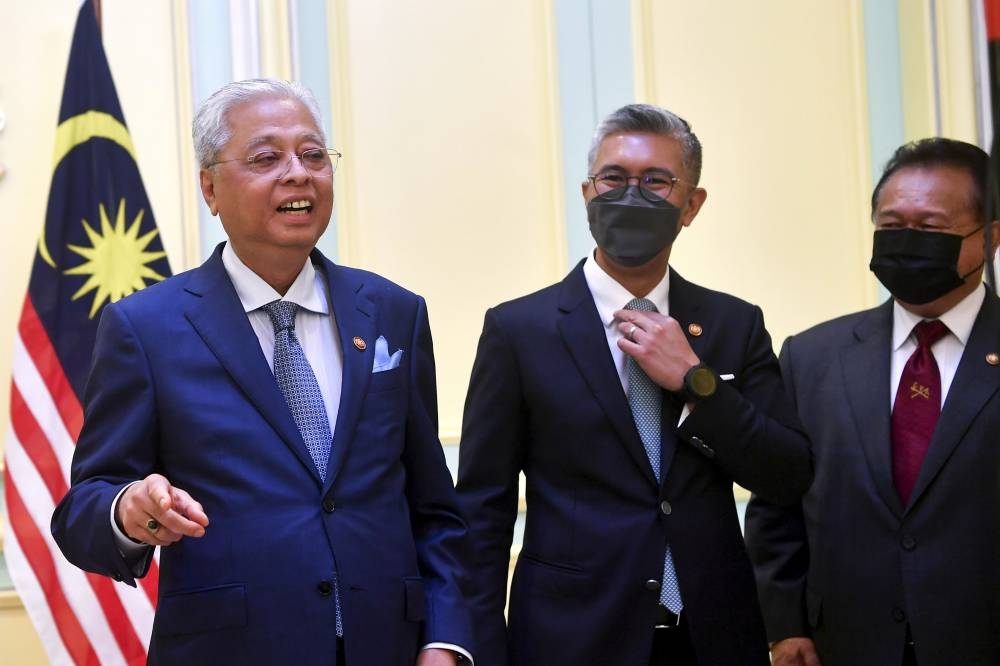 Prime Minister Datuk Seri Ismail Sabri Yaakob (left) with Finance Minister Tengku Datuk Seri Zafrul Abdul Aziz (centre) and Domestic Trade and Consumer Affairs Minister Datuk Seri Alexander Nanta Linggi at a special press conference in Putrajaya, June 22, 2022. — Bernama pic