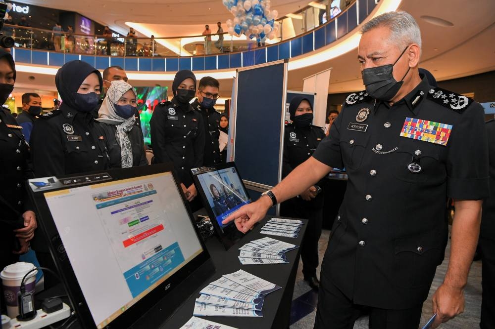 Inspector-General of Police Tan Sri Acryl Sani Abdullah Sani visiting the booth at the opening ceremony of the Royal Malaysia Police's Anti-Scam Campaign 'Let's Fight Scammer Together' in Johor Baru, June 25, 2022. — Bernama pic