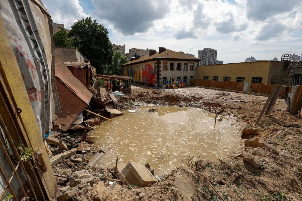 A crater is seen at a compound of a kindergarten after a Russian missile strike, as Russia's attack on Ukraine continues, in Kyiv, Ukraine June 26, 2022. — Reuters pic