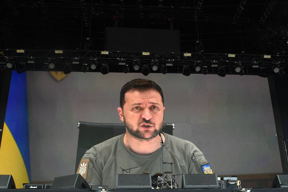 Ukraine's President Volodymyr Zelensky addresses festivalgoers via a video link during the Glastonbury festival near the village of Pilton in Somerset, southwest England, on June 24, 2022. — AFP pic