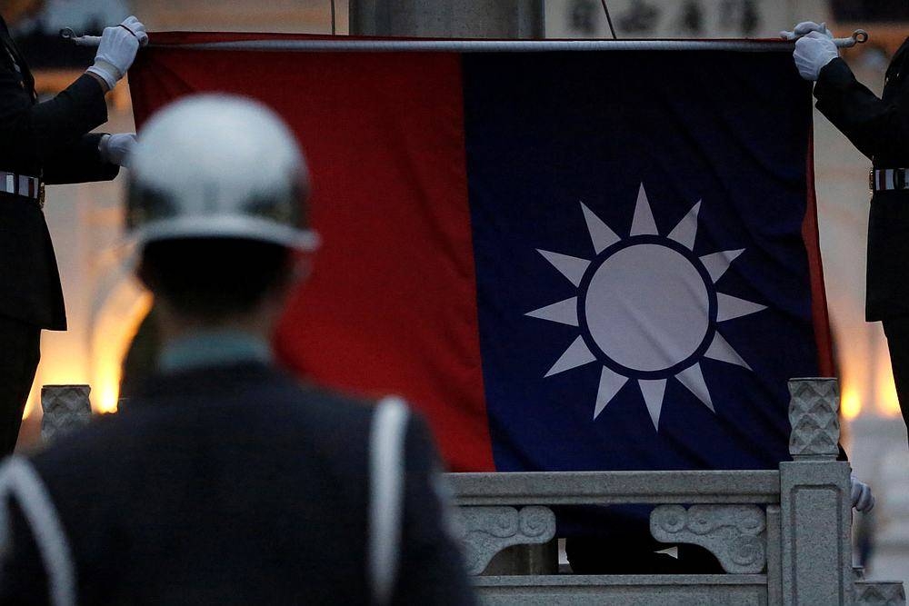 Honour guards perform Taiwan national flag lowering ceremony at Liberty Square, as the spread of the Covid-19 continues, in Taipei April 1, 2020. — Reuters pic