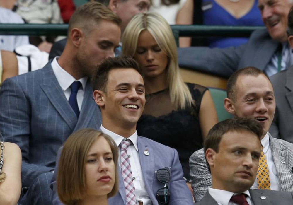 Diver Tom Daley (centre) sits on Centre Court at the Wimbledon Tennis Championships, in London June 28, 2014. — Reuters pic