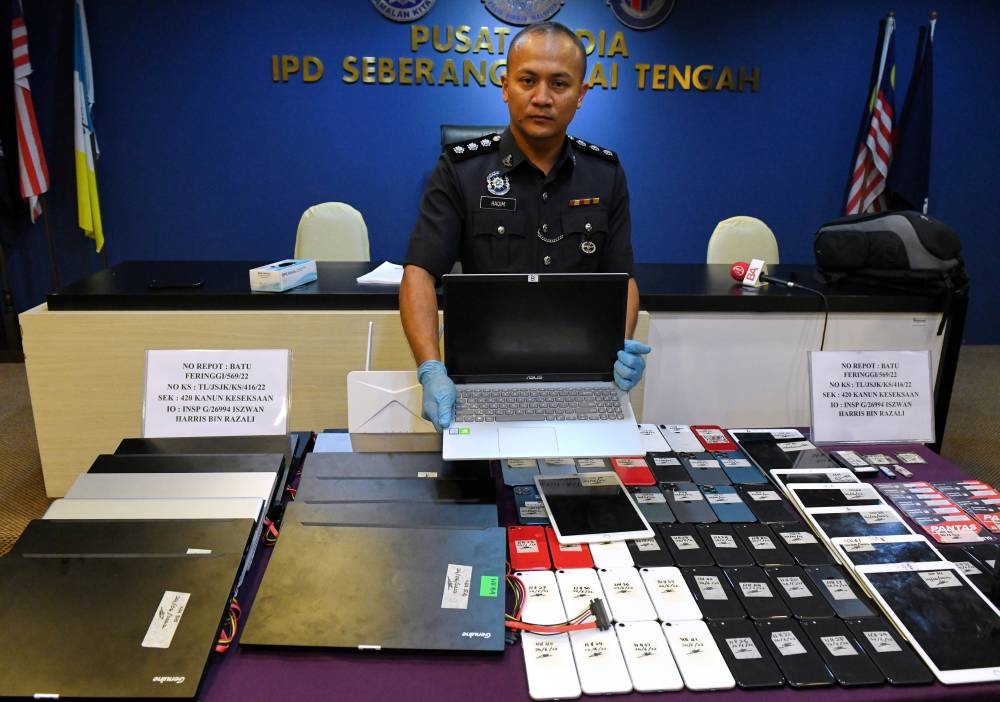 Penang police chief Datuk Mohd Shuhaily Mohd Zain with equipment seized from a syndicate carrying out online fraudulent activities and arrested 23 Taiwanese suspects aged between 19 and 48 at a premises in Batu Ferringhi, June 27, 2022. — Bernama pic 