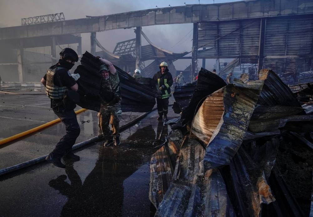 Rescuers and service members work at a site of a shopping mall hit by a Russian missile strike, as Russia's attack on Ukraine continues, in Kremenchuk, in Poltava region, Ukraine June 27, 2022. ― Reuters pic